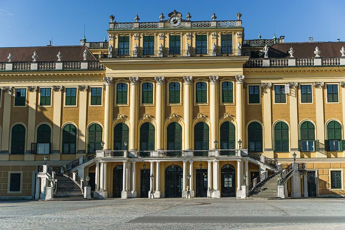 Prachtvolle Fassade des Schlosses Schönbrunn in Wien mit leuchtend gelben Wänden und eleganten Säulen