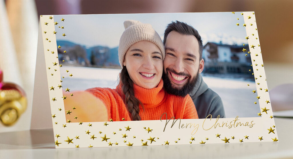 Eine festliche Grußkarte mit goldenen Sternen und der Aufschrift 'Merry Christmas'.