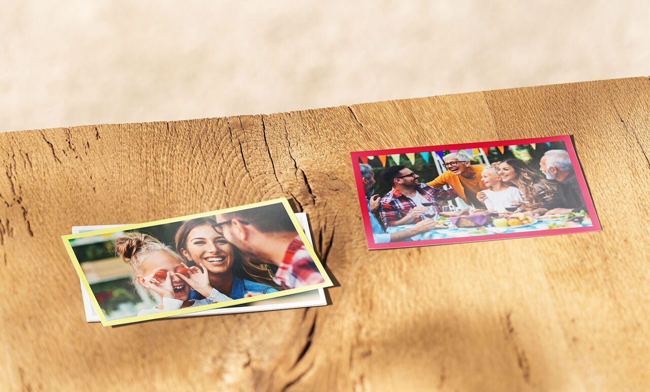 Fünf bunte Fotos von unvergesslichen Momenten auf einem Holztisch.