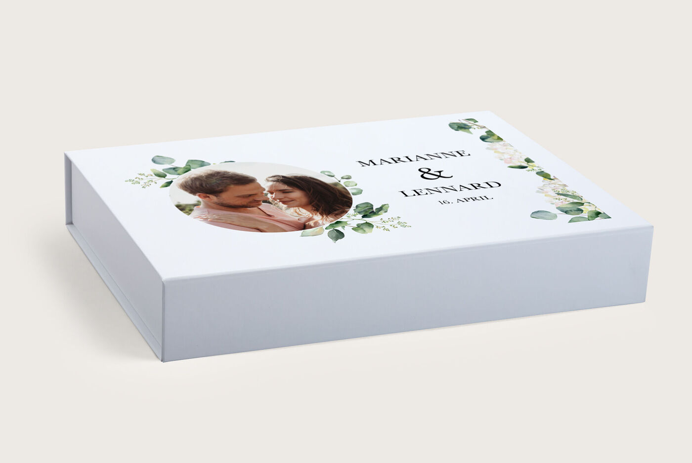 Ein wunderschönes CEWE Fotobuch mit einem romantischen Paar, umgeben von grünen Blättern und Blumen. Ein persönliches Geschenk mit Liebe gestaltet.