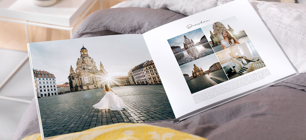 Eine Braut in einem weißen Kleid dreht sich glücklich in der Altstadt von Dresden mit historischem Stadtschloss im Hintergrund. Das CEWE FOTOBUCH zeigt eine wunderschöne Hochzeitsbilder-Sammlung.